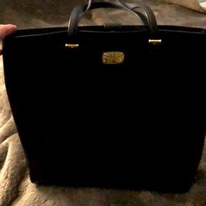 Michale Kors black tote with magnetic closure and inside pockets .